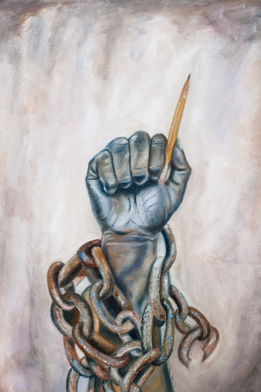 A fist with a pencil 