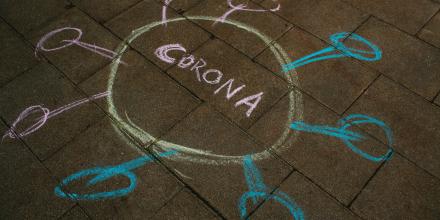 Corona chalk drawing on the ground